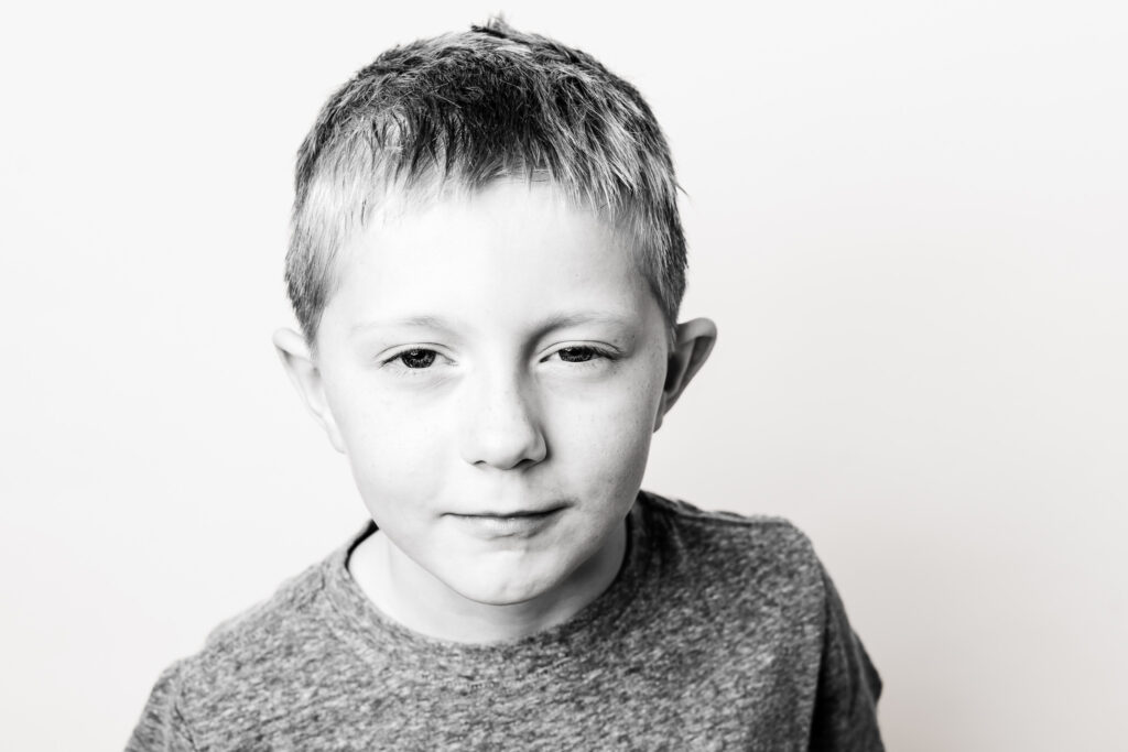 Black and white personality portrait of a child with a calm expression, photographed in Cleveland