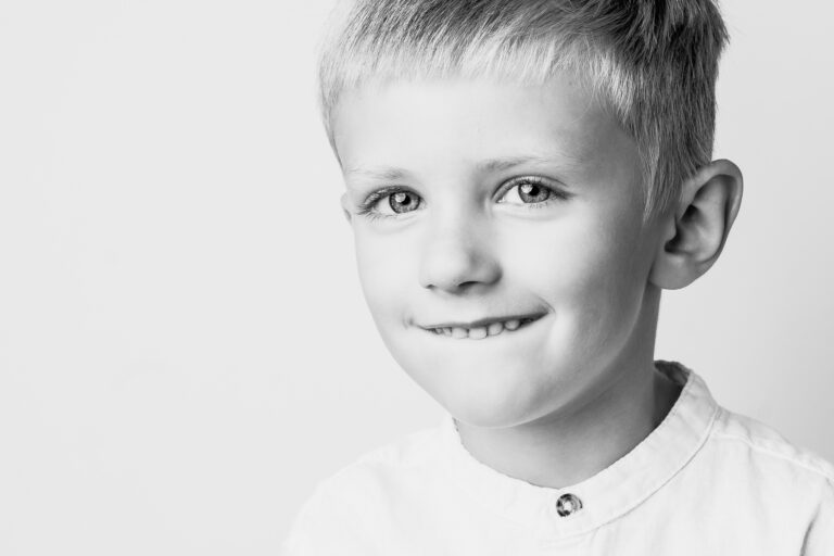 Smiling child during a black and white personality portrait session in Cleveland