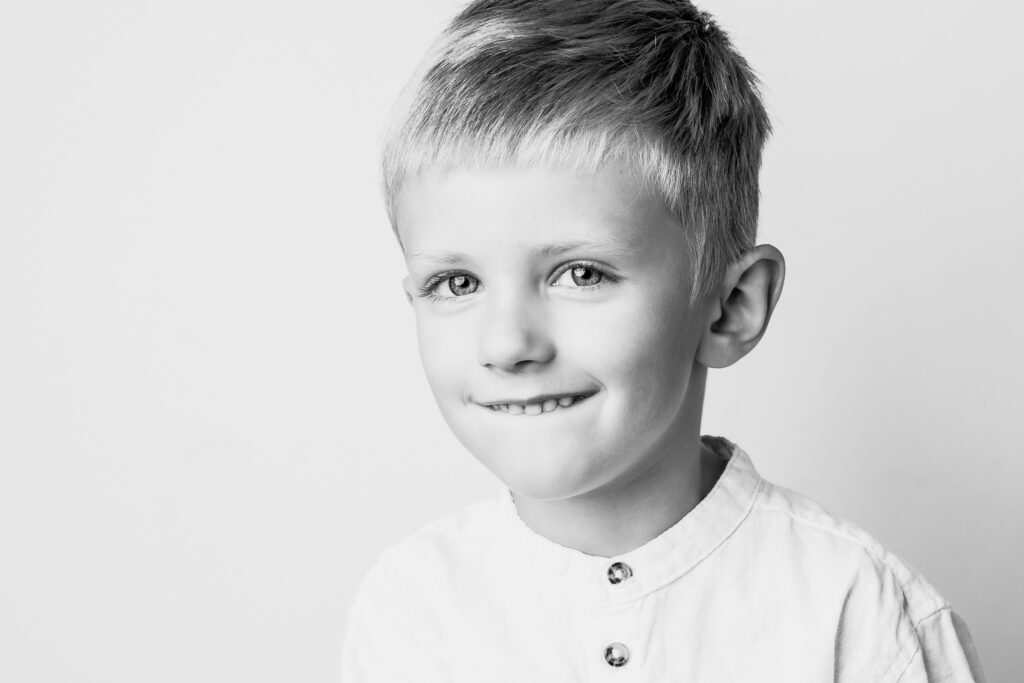 Black and white personality portrait of a smiling child, photographed in Cleveland